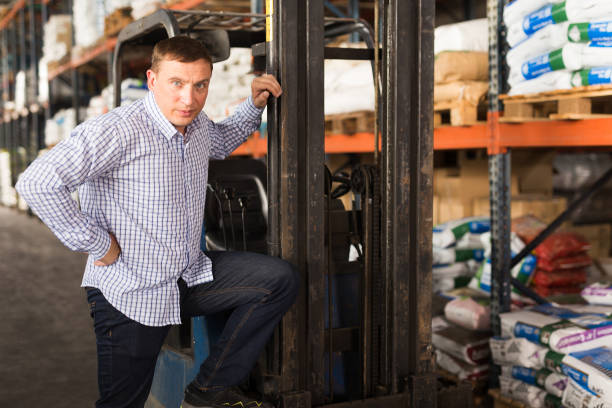 istock Man near forklift in hypermarket 1332183195