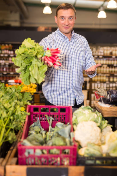 istock Happy customer buying radish at supermarket 1332183199