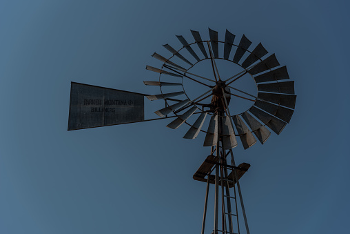 Unused but turning ranch windmill in rural Montana in Musselshell county in western USA. John Morrison Photographer