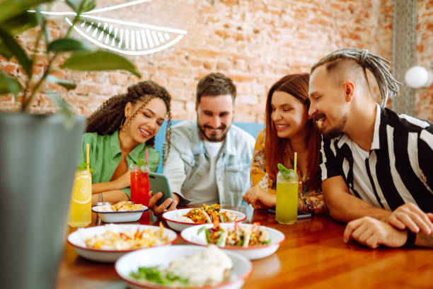 istock Happy friends having a great time in cafe. 1332188811