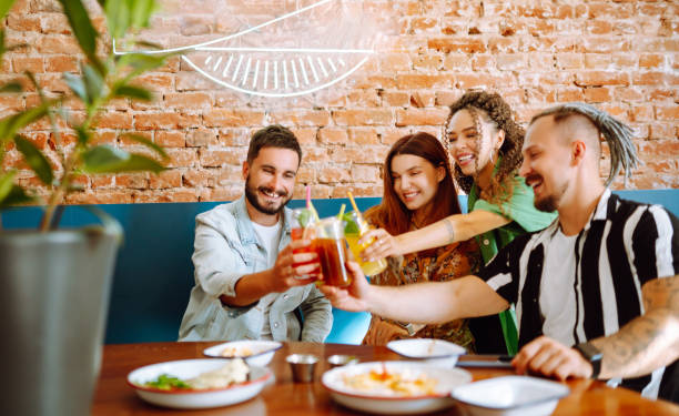 istock Happy friends having a great time in cafe. 1332190144