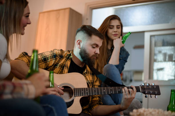 istock Friends on a house party playing guitar and having fun 1332190938