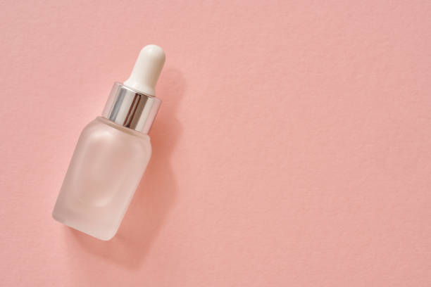 istock A bottle of aromatherapy essential oil on pastel pink background 1332193476