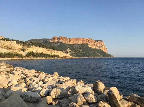 Photo of View of the Château de Cassis and Cap Canaille headland from the Plage de la Grande Mer beach on a summer sunny day in Cassis, located in the Provence-Alpes-Côte d'Azur region, on the French Riviera.