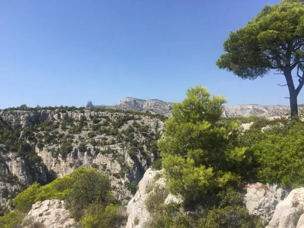 Photo of Mont Puget mountain and the Grande Candelle seen from the cliffs of  the Calanque d'En Vau, one of the most beautiful, but also most isolated, creeks in the Calanques National Park in Marseille.  It is very confined with high and steep cliffs.