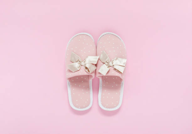 istock Pink home slippers on a pastel pink background. Top view. 1332196883