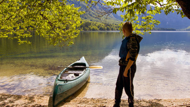 istock Child kayaking in nature 1332198294