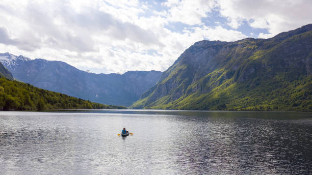 istock Kayakers paddling toward a mountain 1332198330
