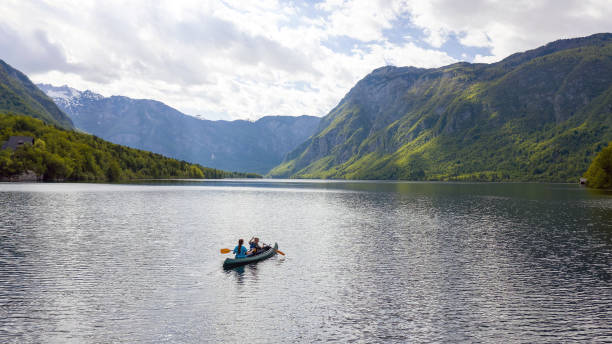 canoeing on a mountain lake - family kayaking kayak canoeing imagens e fotografias de stock