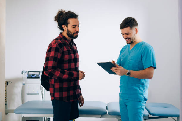 istock Physical Therapy: Doctor And Patient Standing At The Doctor's Office 1332205299