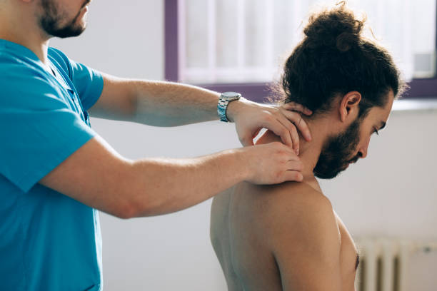 istock Physical Therapy: Doctor Is  Doing Neck Medical Exam 1332205357