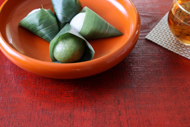 istock Japanese dumpling wrapped in bamboo leaf on the lacquerware board. 1332206577