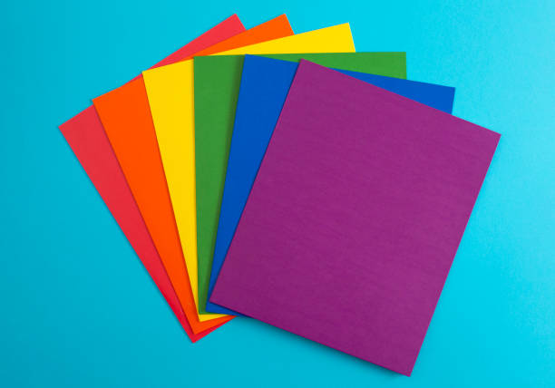istock Rainbow Folders of School or Office Supplies on a Bright Blue Background 1332207391