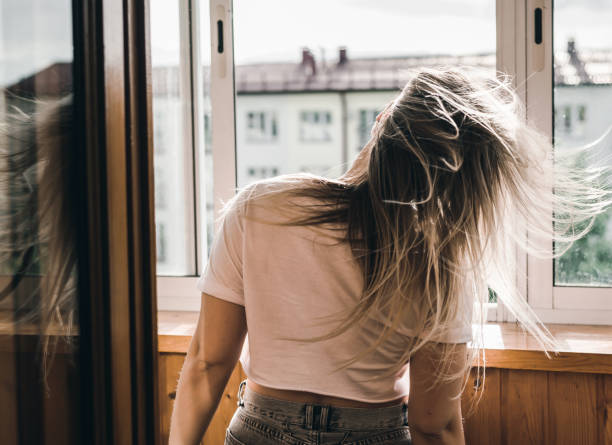 istock Young pretty dark-haired girl dancing at the window 1332209084