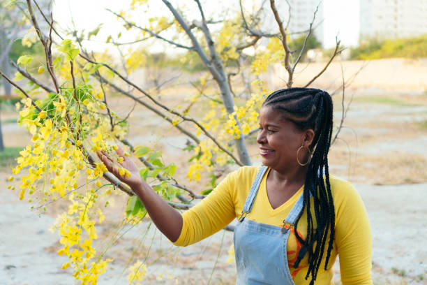 istock Beautiful woman touching the branches of a tree 1332211487