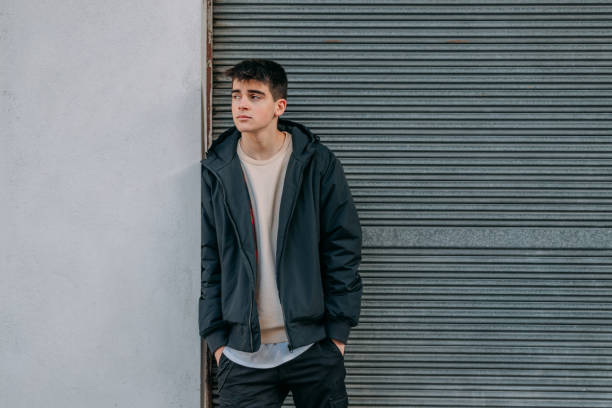 istock young man on the street looking sideways 1332213118