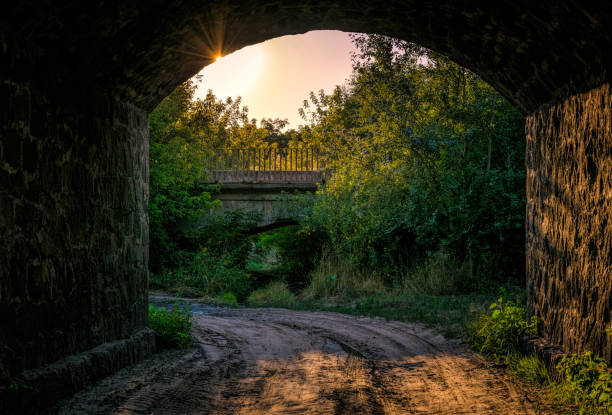 istock Old stone bridge and the light of the evening sun 1332213183