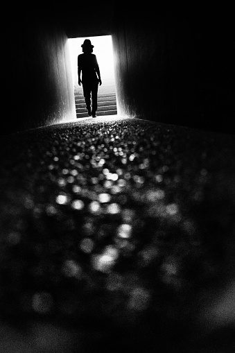 Silhouette of a woman heading to the exit