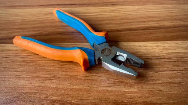 istock a yellow-blue pliers on the wooden table 1332223954