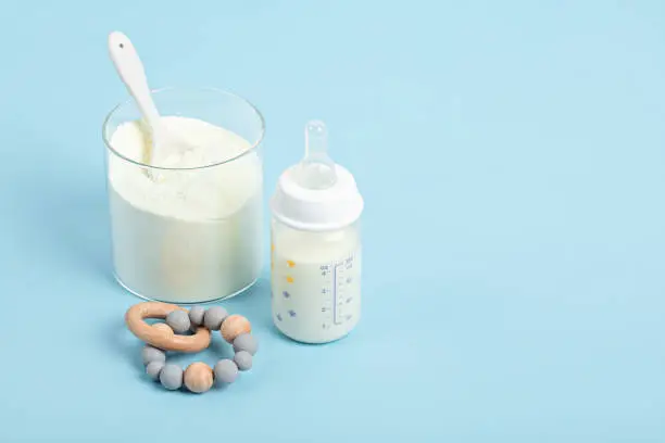 Photo of Preparation of formula for baby feeding. Baby health care, organic mixture of dry milk idea