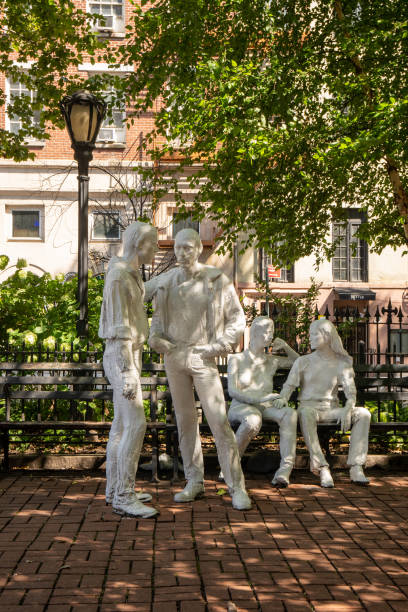 View of the sculpture Gay Liberation by American artist George Segal, located in Christopher Park along Christopher Street in the West Village section of Manhattan. New York, NY - USA - July 30, 2021: View of the sculpture Gay Liberation by American artist George Segal, located in Christopher Park along Christopher Street in the West Village section of Manhattan. logan west stock pictures, royalty-free photos & images