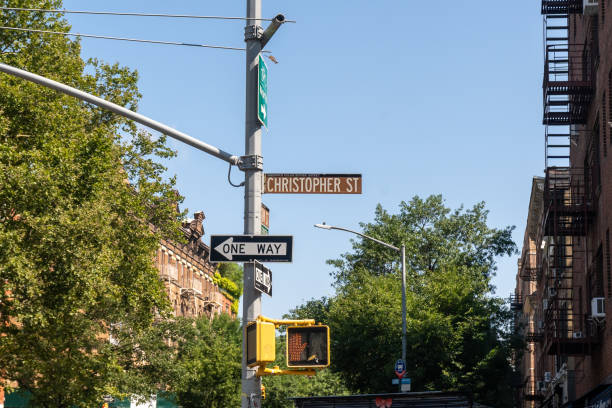 A street sign for Christopher Street; in the West Village neighborhood of Manhattan. Famous for the Stonewall Inn and the beginning of Gay Rights Movement. New York, NY - USA - July 30, 2021: A street sign for Christopher Street; in the West Village neighborhood of Manhattan. Famous for the Stonewall Inn and the beginning of Gay Rights Movement. logan west stock pictures, royalty-free photos & images