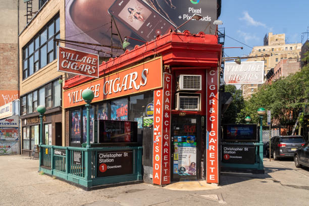 Village Cigars, an iconic symbol of Greenwich Village. A tobacco shop located on a tiny triangular-shaped space at 7th Ave S, Christopher St. and West 4th St. New York, NY - USA - July 30, 2011: Village Cigars, an iconic symbol of Greenwich Village. A tobacco shop located on a tiny triangular-shaped space at 7th Ave S, Christopher St. and West 4th St. logan west stock pictures, royalty-free photos & images