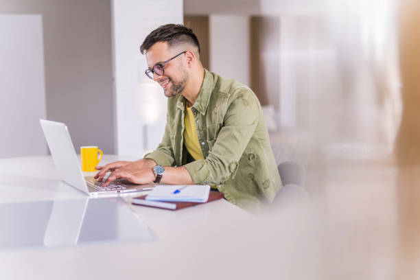 istock Young man working on his laptop at home. 1332230595