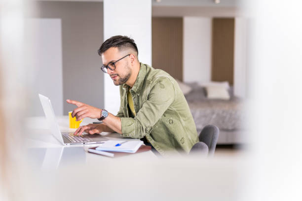 istock Young man working on his laptop at home. 1332230599