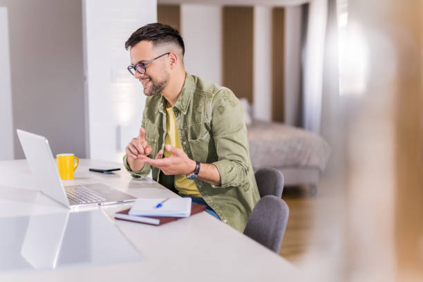 istock Young man going talking with a client online on his laptop. 1332230666