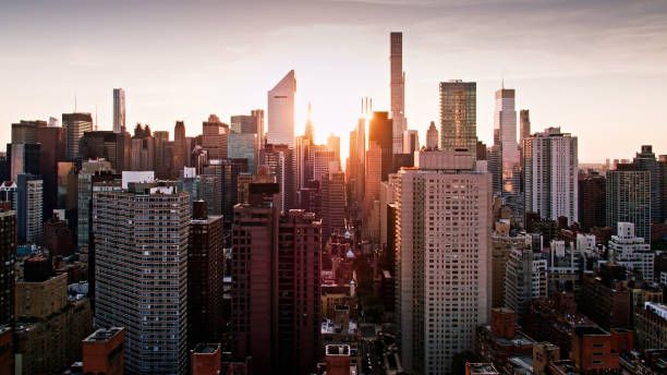istock Sun Setting Down New York Streets at Dusk from East River - Aerial 1332231337