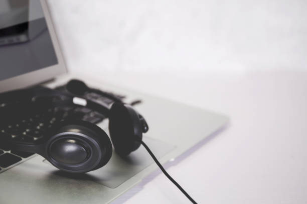 istock Laptop computer and headphone on desk, e-learning online, webinar for education and learning, seminar with notebook, video conference, headset for multimedia, course and classroom to internet. 1332231386