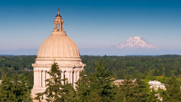 Washington State Capitol Building with Mt Rainier in Distance Aerial shot of the state capitol building in Olympia, Washington on a summer afternoon, with the snowy mass of Mt Rainier/Tahoma in the distance. washington state stock pictures, royalty-free photos & images