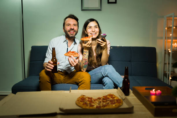 istock Latin boyfriend and girlfriend watching tv 1332234104