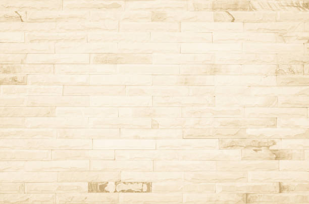 istock Empty background of wide cream brick wall texture. Beige old brown brick wall concrete or stone textured, wallpaper limestone abstract flooring/Grid uneven interior rock. Home decor design backdrop. 1332240355