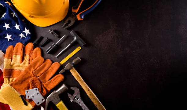 istock Happy Labor day concept. American flag with different construction tools on dark stone background. 1332242757