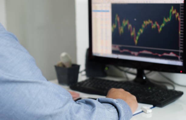istock abstract business blur, people working and watching graph trading investment concept. 1332243676