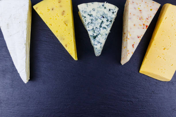 istock Set of various types of cheese on black slate background. Top view 1332247667