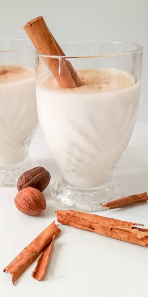istock Refreshing white creamy drink, cinnamon and nutmeg. on white background 1332248846