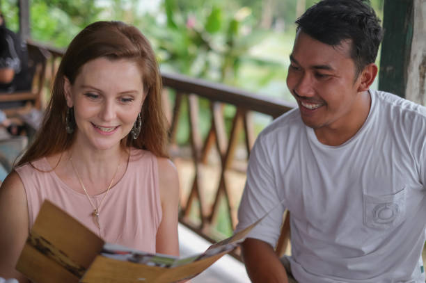 istock Multi-Ethnic Couple Ordering Food in Local Restaurant 1332249763