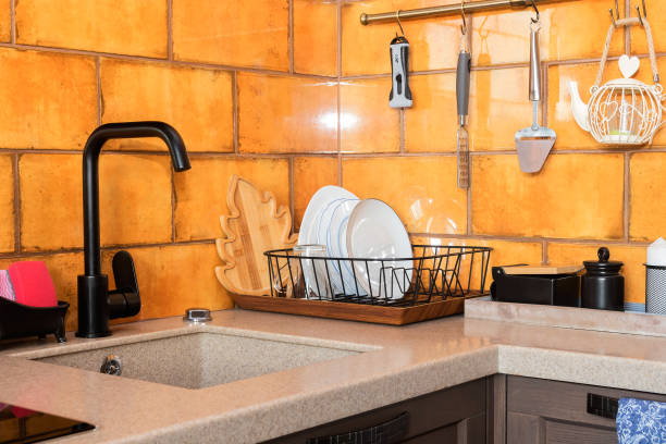 istock Modern kitchen design with black sink mixer and ocher ceramic tiles. 1332250887