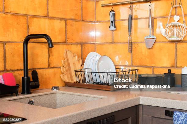 Modern Kitchen Design With Black Sink Mixer And Ocher Ceramic Tiles Stock Photo - Download Image Now