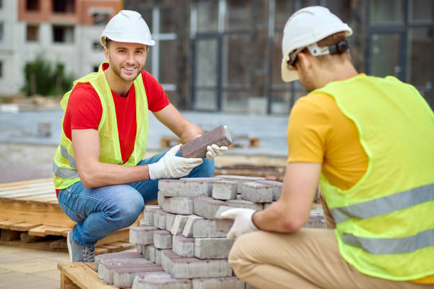 istock Two skilled workers in cotton gloves selecting external paving materials 1332251137