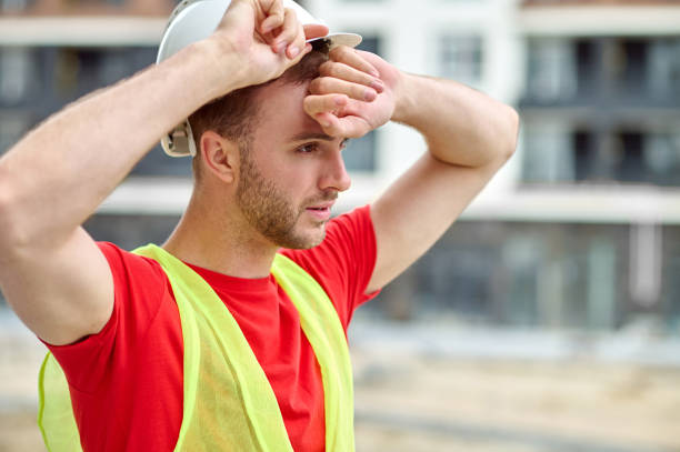 istock Exhausted male builder wiping sweat off his forehead 1332251234