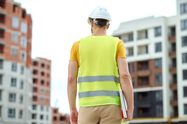 istock Worker in a reflective waistcoat standing on the building site 1332251308
