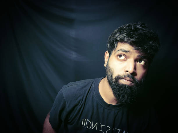 istock Indian guy with beard with black banner in background 1332252154