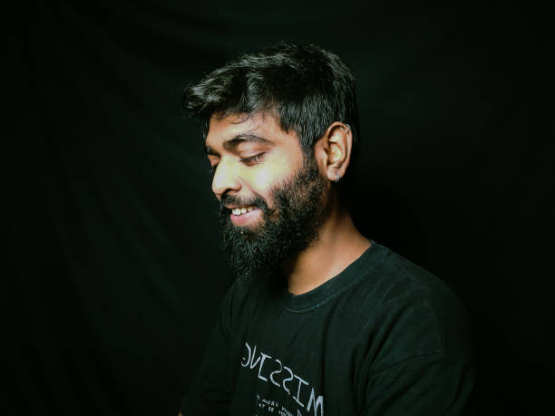 istock Indian guy with beard close studio shot with black background and facial expressions 1332252453