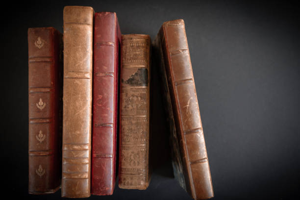 Row of old books on black background