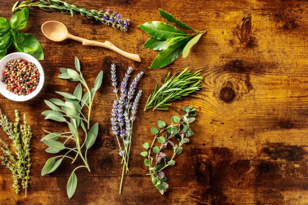 istock Fresh aromatic herbs, shot from above on a rustic wooden background 1332268316