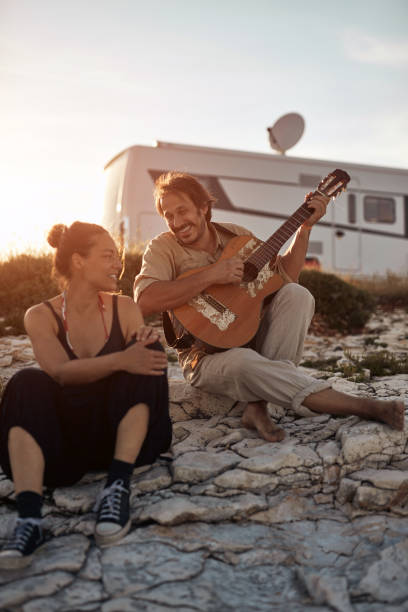 istock Man singing to his girlfriend on a beach. 1332269637
